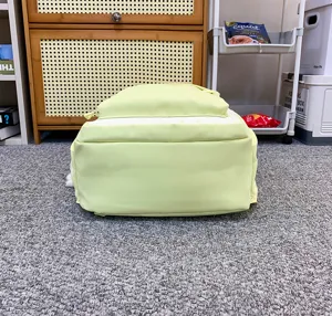 Light green casual student backpack with large capacity, durable fabric and clean design.