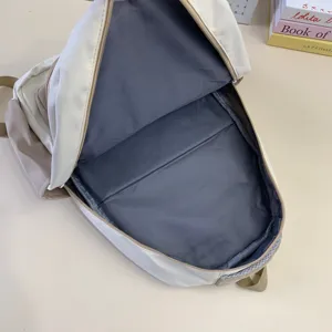 Minimalist casual backpack interior detail view, spacious daily school book bag in beige grey.