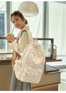 Floral school backpack with cute bear pendant, large capacity casual daily daypack for women and students.