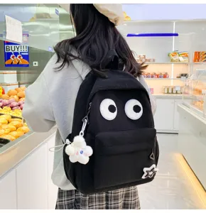 Cute corduroy backpack for women, large capacity student school bag with big eyes design.