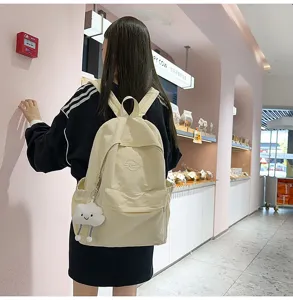 Japanese style casual canvas backpack for women, lightweight school bag with cute cloud pendant.