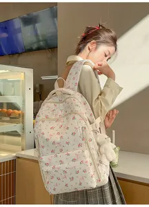 Chic floral backpack for women, cute bow design, large capacity school bag for daily use.