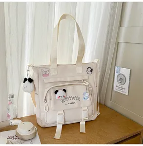 Large capacity canvas tote bag for daily use, school, and travel with cute plush pendants.