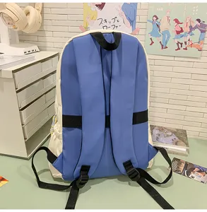 Detail shot of a blue and white colorblock student backpack placed on desk with decor.