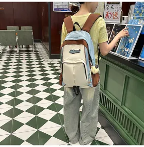 Stylish color-block backpack for students with multiple compartments and casual design.