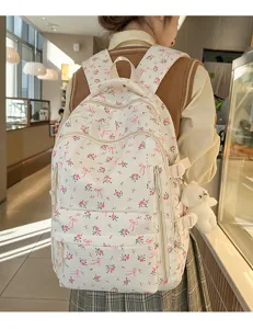 Floral print backpack with cute bow design, lightweight and spacious for daily student use.