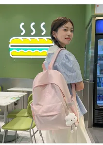 Casual pink canvas backpack for school, travel, and daily use with cute cloud pendant.