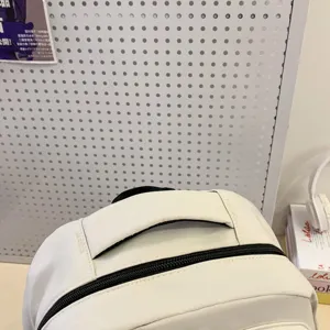 White casual school backpack detail view, durable double zipper and top handle design.