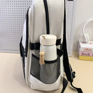 Detail view of large white student backpack with side mesh pocket and stylish black zippers.