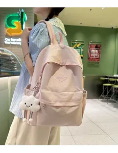 Pink casual campus backpack detailed view, lightweight nylon school bag with cute cloud pendant.