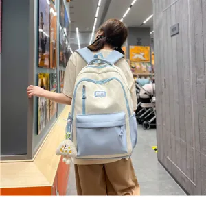 Detailed view of the cute color-block casual student backpack worn by model, large capacity.