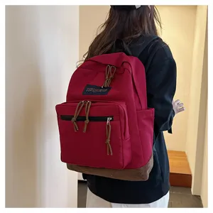 Detail view of the casual canvas backpack featuring suede bottom and secure zipper compartments.