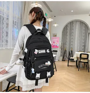 Detailed shot of a large-capacity black school backpack worn by a model in a cozy cafe setting.