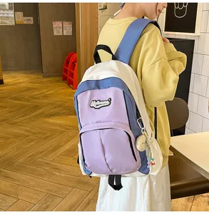 Color-blocked backpack for students, stylish school bag with multiple pockets and custom patch.