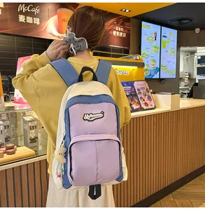 Detail view of the stylish color-blocked school backpack showcasing its front pocket design.