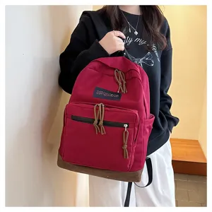 Casual canvas backpack with vintage red design, spacious main compartment and practical front pocket.