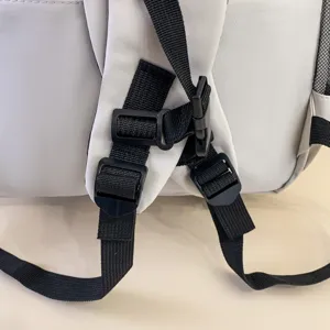 Detail view of backpack shoulder straps with adjustable black buckles and durable fabric.