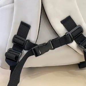 Close up view of the backpack adjustable shoulder straps and durable plastic buckle details.