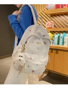 Cute printed school backpack for girls teens large capacity casual daypack with dog pendant.