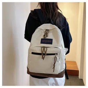 Canvas backpack detail, beige and brown contrast design, casual style for daily use.