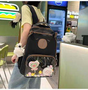 Detail view of cute black student backpack with clear pocket and lovely plush decor style.