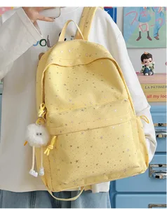 Detail view of yellow star pattern canvas backpack, large capacity school bag for daily use.