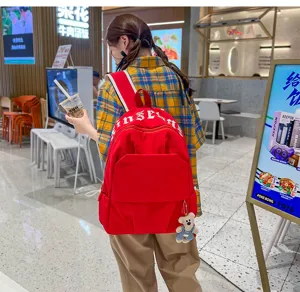 Korean style casual large capacity nylon backpack detail view, vibrant red school bag.