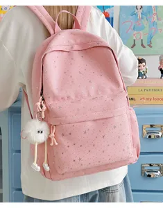 Pink star print canvas backpack with plush doll pendant, stylish large capacity school bookbag.