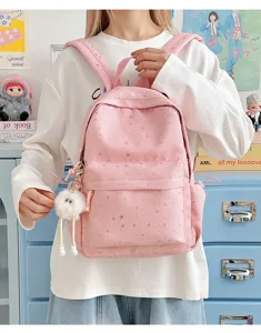 Detailed view of pink star pattern casual backpack with cute plush pendant for daily use.