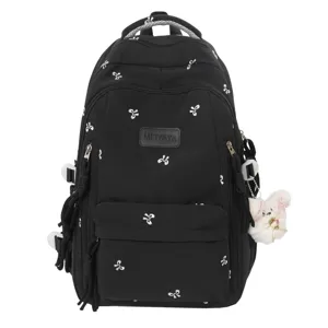 Black backpack for students with cute white bow embroidery, stylish school bag for travel.