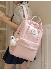 Cute pink backpack for teen girls, large capacity Japanese style school bookbag for daily use.