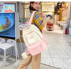 Detailed view of stylish color-block backpack in casual restaurant setting, large daily capacity.