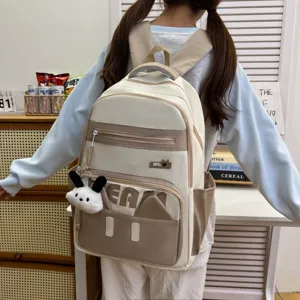 Cute beige canvas backpack detail view featuring sweet ins style, bear ears and plush pendant.