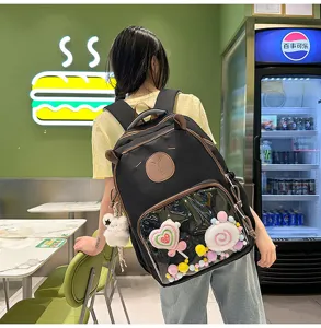 Detail view of the black school backpack with cute bear ears and clear front window pocket.