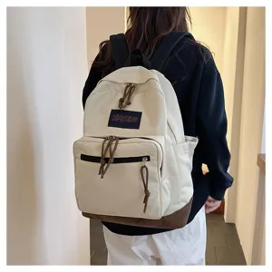 Canvas casual backpack for students, stylish travel computer bag with multi-pocket design.