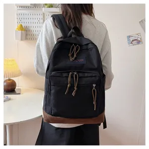 Casual canvas backpack with suede bottom and zipper pullers for daily school travel wear.