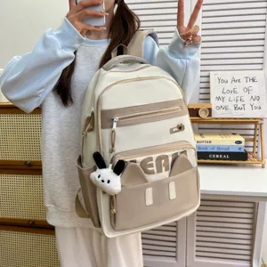 Cute cat ear school backpack, casual beige student book bag with plush bunny pendant for youth.