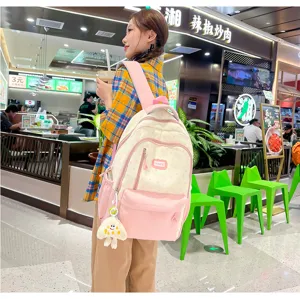 Detail view of the cute color-matching canvas backpack showing large capacity and zippers.