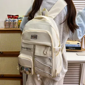 Detailed view of cream white large capacity school backpack with multiple pockets and drawstring.