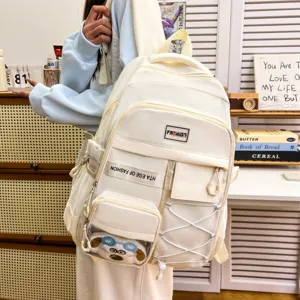 Detailed view of the multi-pocket cream white school backpack with transparent front pouch.