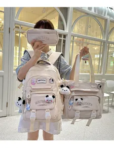 Detailed view of beige multi-piece backpack set with cute plush charms and clear style.