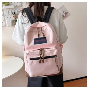 Casual pink canvas school backpack with front pocket, stylish design for students and travel.