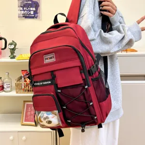 Details of the large capacity red school backpack featuring multiple pockets and durable straps.