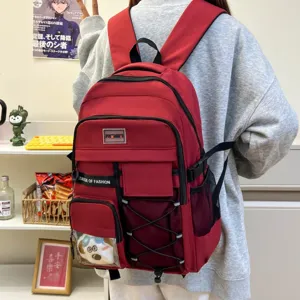 Red large capacity student backpack detail view, showing multi-pocket design and trendy straps.
