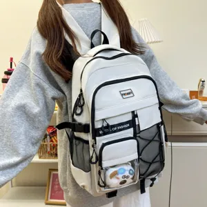 Detail shot of white student backpack with multi pockets and clear front compartment for cute doll.