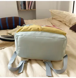 Detailed view of the multi-colored color-blocking backpack showing straps and pockets.