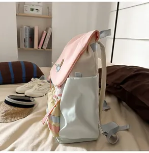 Side detail view of colorblock student backpack, showing multi-pocket design and fabrics
