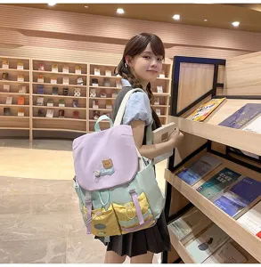 Dopamine color-blocking student backpack with large capacity, cute bear badge and multi pockets.