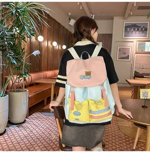 Colorful color block student backpack with cute bear patch, multi-pocket casual daily bag.