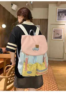 Colorful dopamine school backpack detail view showing cute bear patch and multi-pocket design.